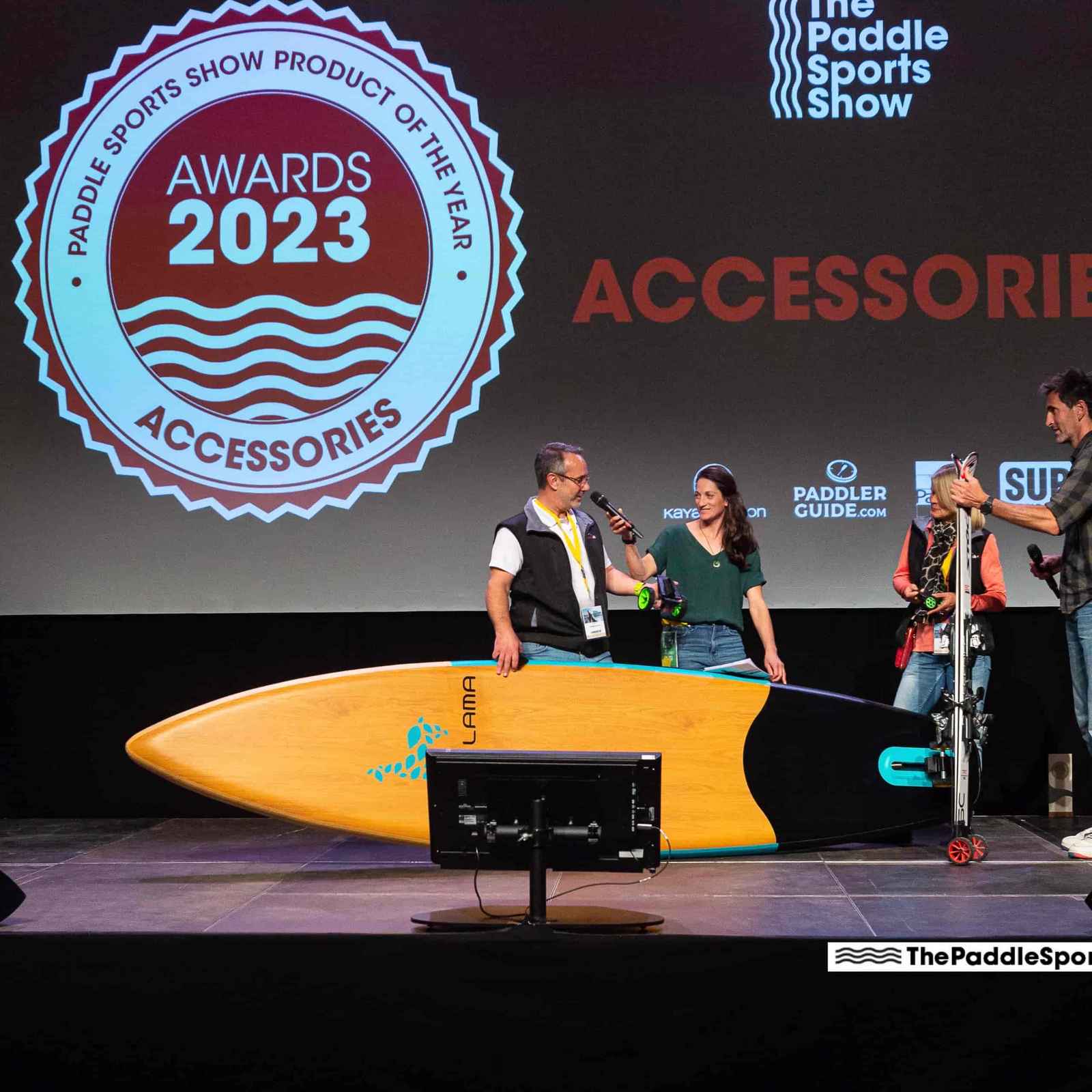Scene on a stage with SUP and skis, awarded the Paddle Sports Show Award 2023 for accessories.