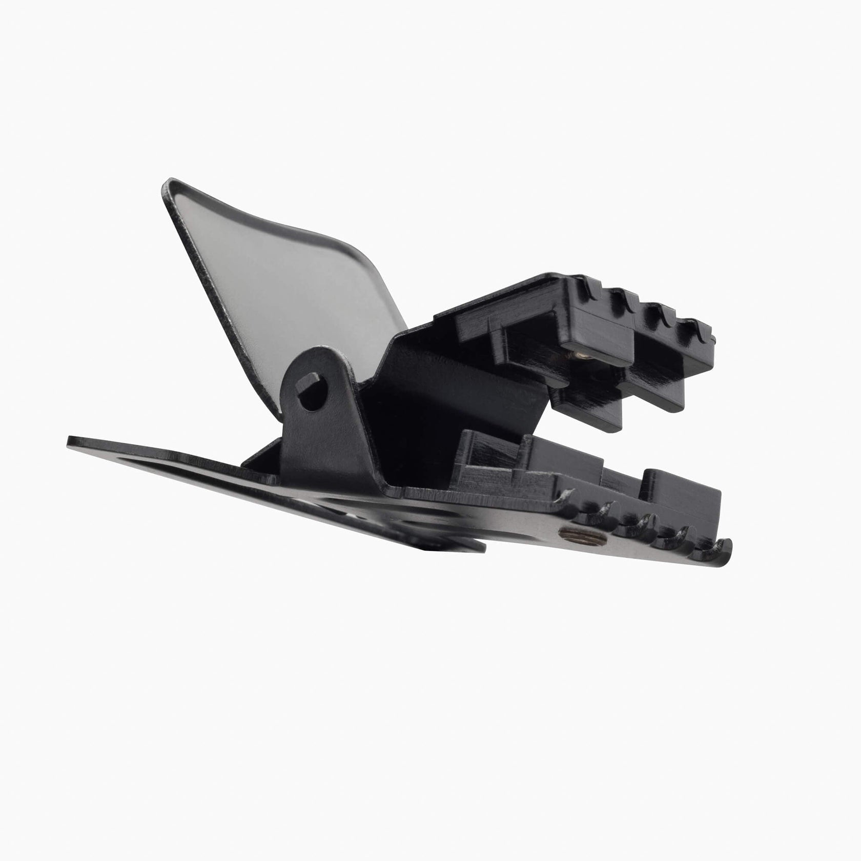 Gros plan d'une pince noire, avec la partie supérieure ouverte et transparente, sur un fond blanc.