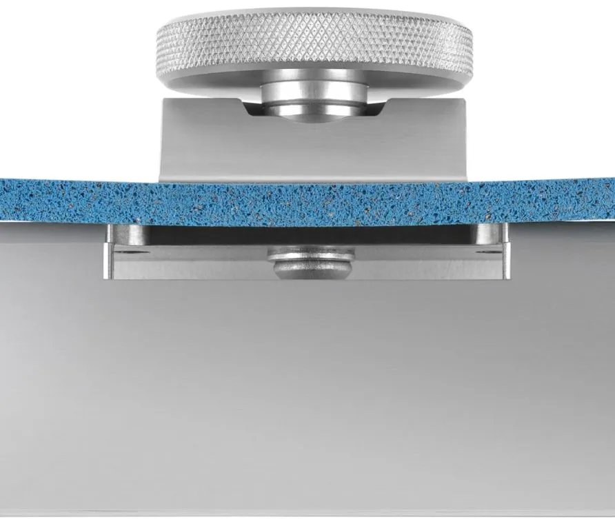 Close-up of a silver screwing device attached to a blue, porous material.