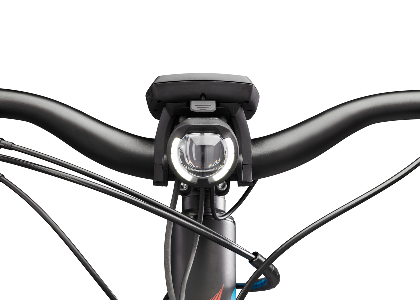 Nahaufnahme einer leuchtenden E-Bike Beleuchtung (Lupine SL B Bosch) am Lenker eines Fahrrads. Kabel sind sichtbar.