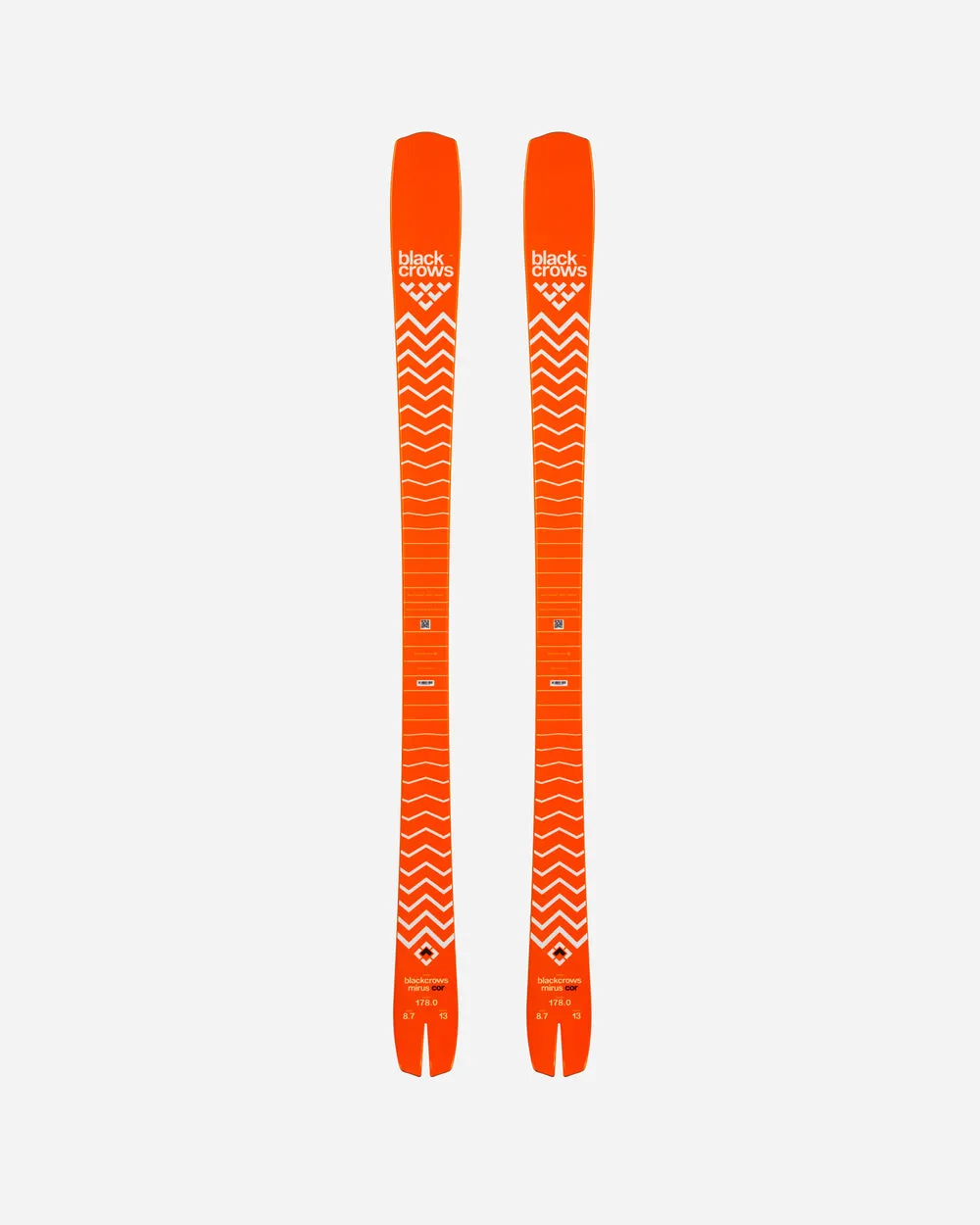 Zwei orangefarbene Ski mit weißem Zickzackmuster auf weißem Hintergrund, von oben betrachtet. Auf dem Ski befindet sich der Schriftzug "black crows".