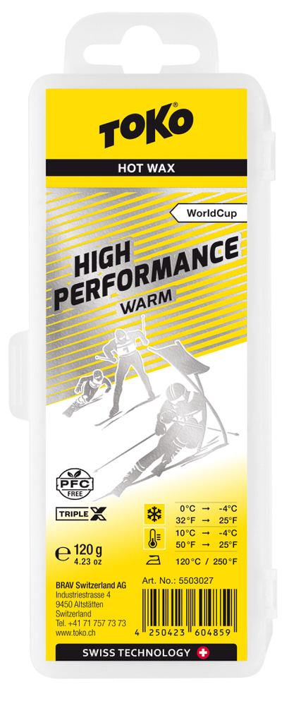 Verpackung Toko High Performance Triple X Warm Heißwachs, gelb-silber Design mit Skifahrer-Illustration und Temperaturhinweis.