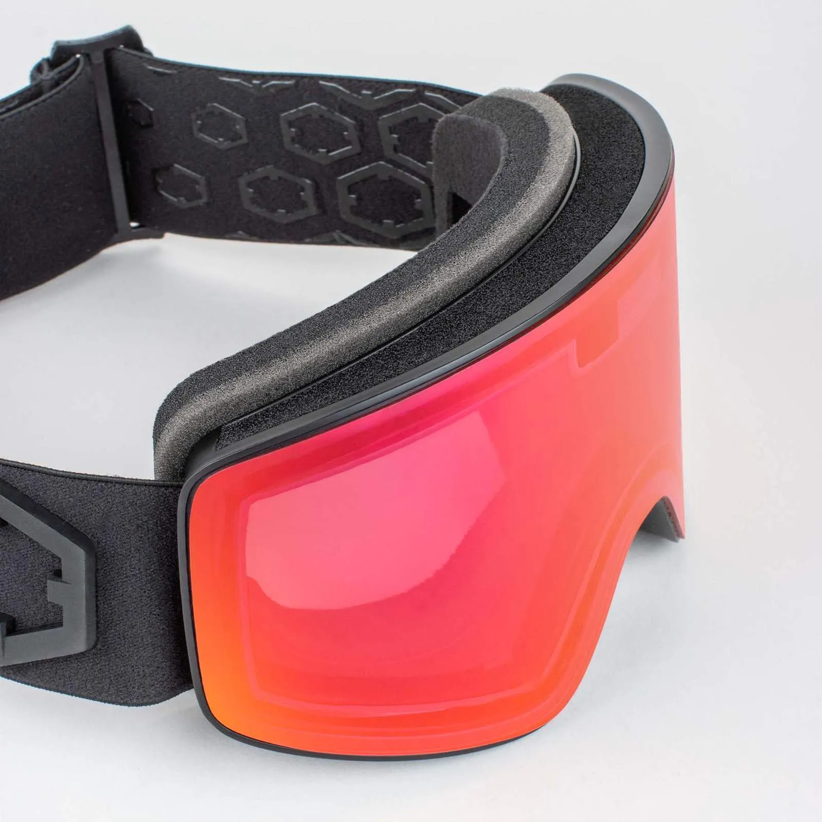 Close-up of the Outof Electra 2 ski goggles with red tinted lenses and black, adjustable strap.