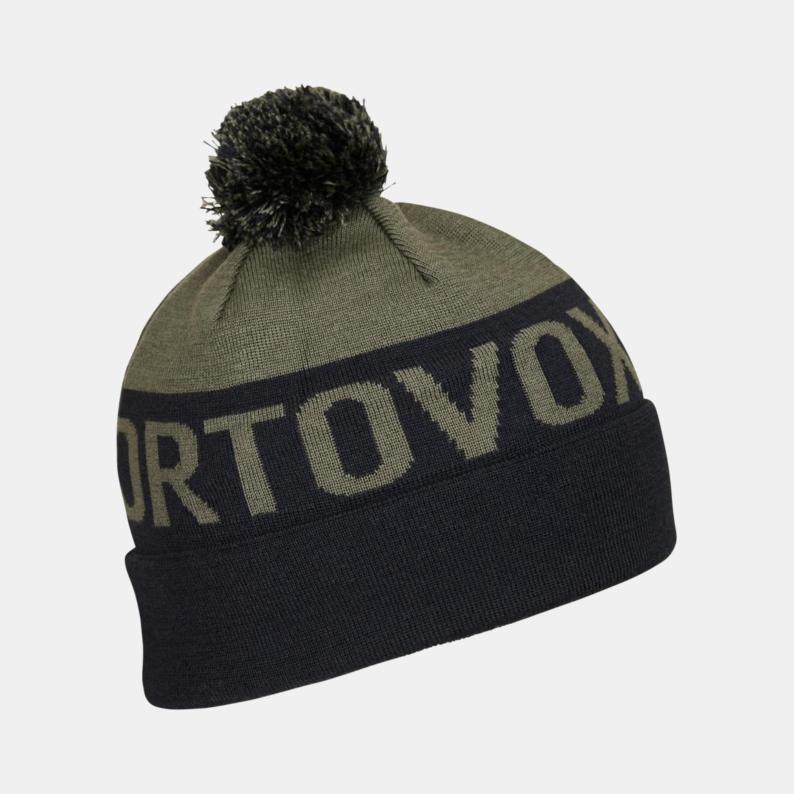 Bonnet vert Ortovox  Bonnet tricoté vert Ortovox avec un pompon foncé et le mot "Ortovox" sur la partie centrale foncée.