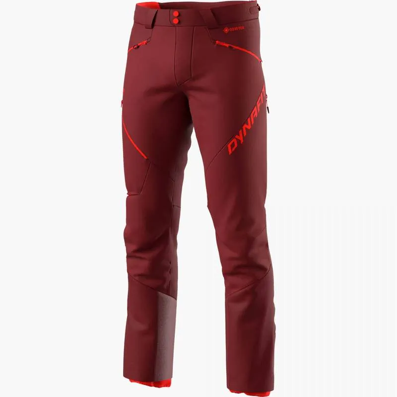 Freestanding, red Dynafit Radical Infinium Hybrid pants for men, with red accents and logos.