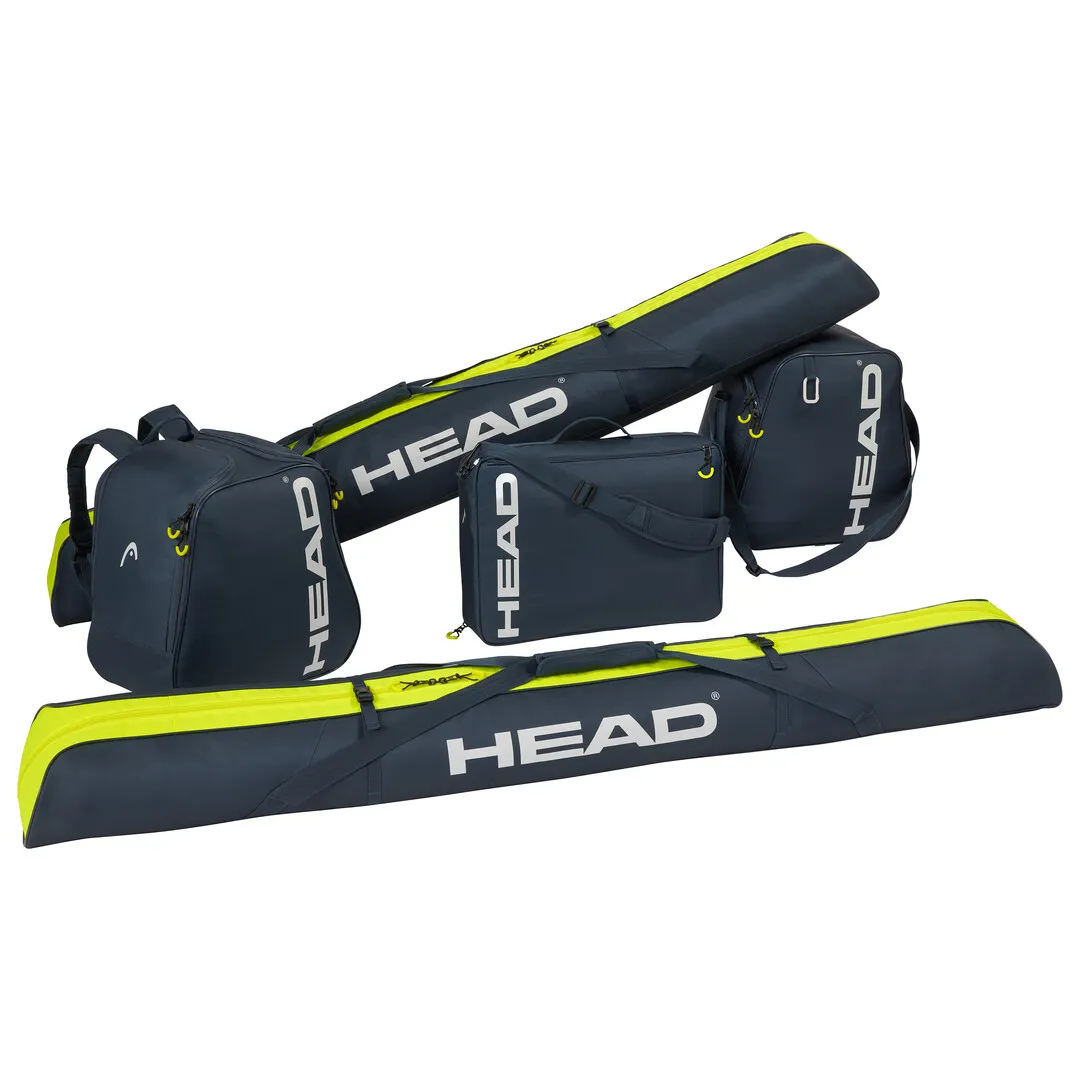 Sac de ski bleu et jaune HEAD 175cm, sac à chaussures de ski, sac à dos et sac à bandoulière sont empilés sur un fond blanc.