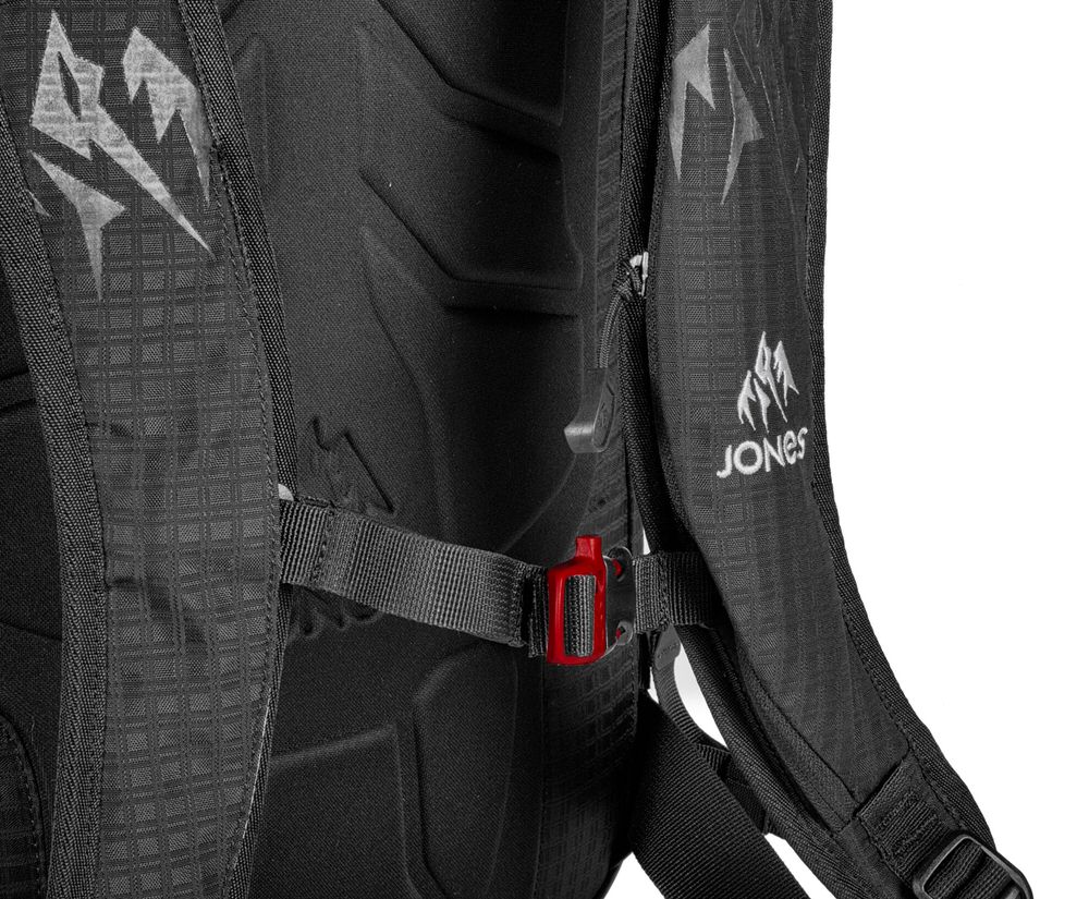 Detailed view of the black Jones DSCNT 19L Backpack, with red clip closure.