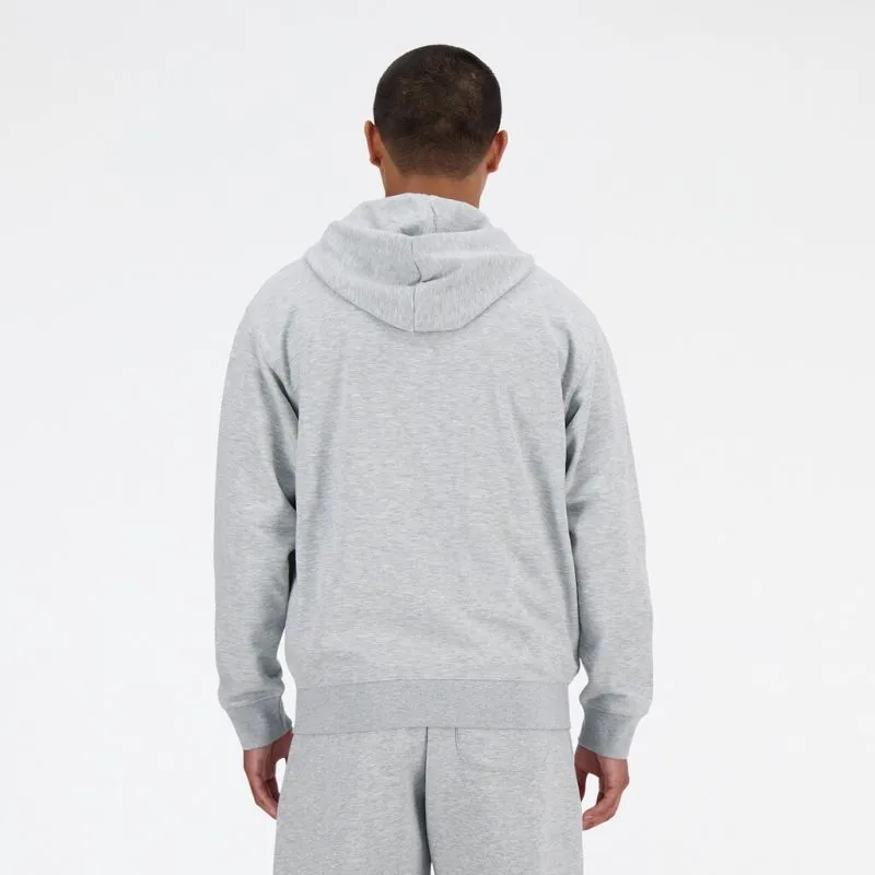 Back view of a man wearing a gray New Balance Stacked Logo French Terry FZ Hoodie with hood.