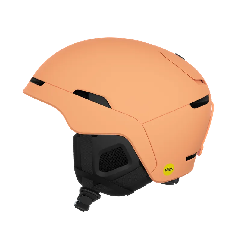 Peach-colored ski helmet with black accents and a yellow MIPS sticker.