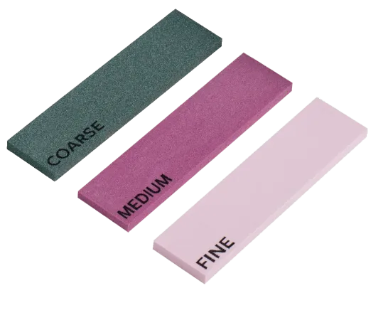 Three whetstones: coarse (green), medium (pink), fine (pink). Labeling in black lettering on each stone.