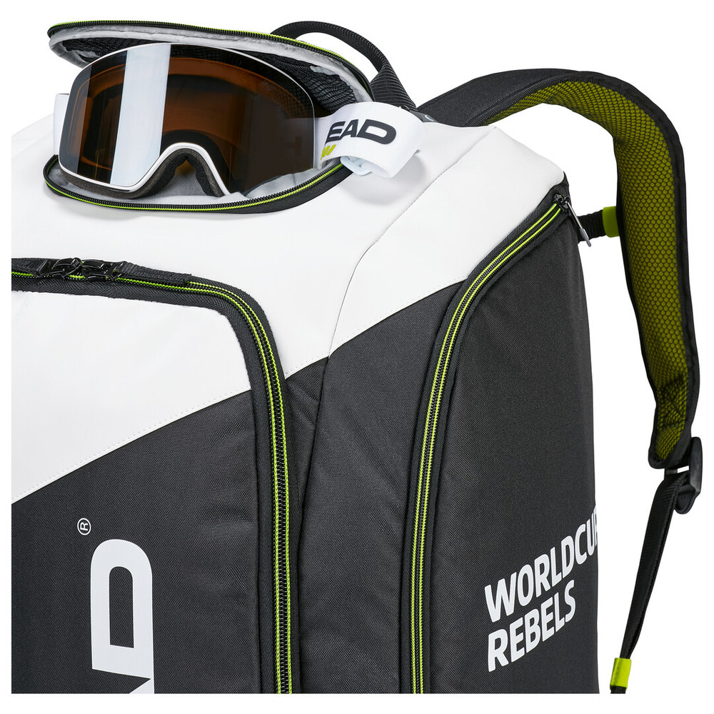 Head Rebels Racing Backpack S, black and white with ski goggles in helmet compartment.