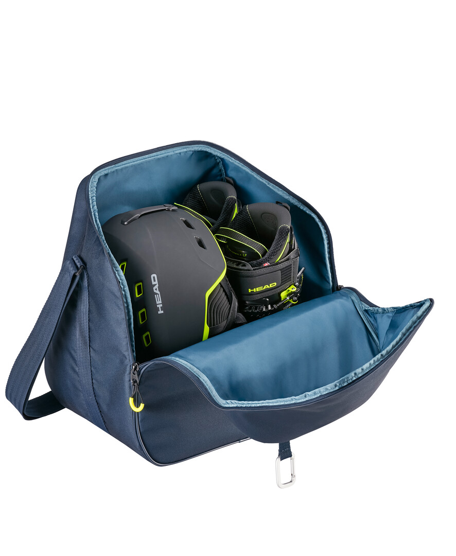 Offene, marineblaue Head Bootbag mit blauem Innenfutter, Helm und Skischuhen.