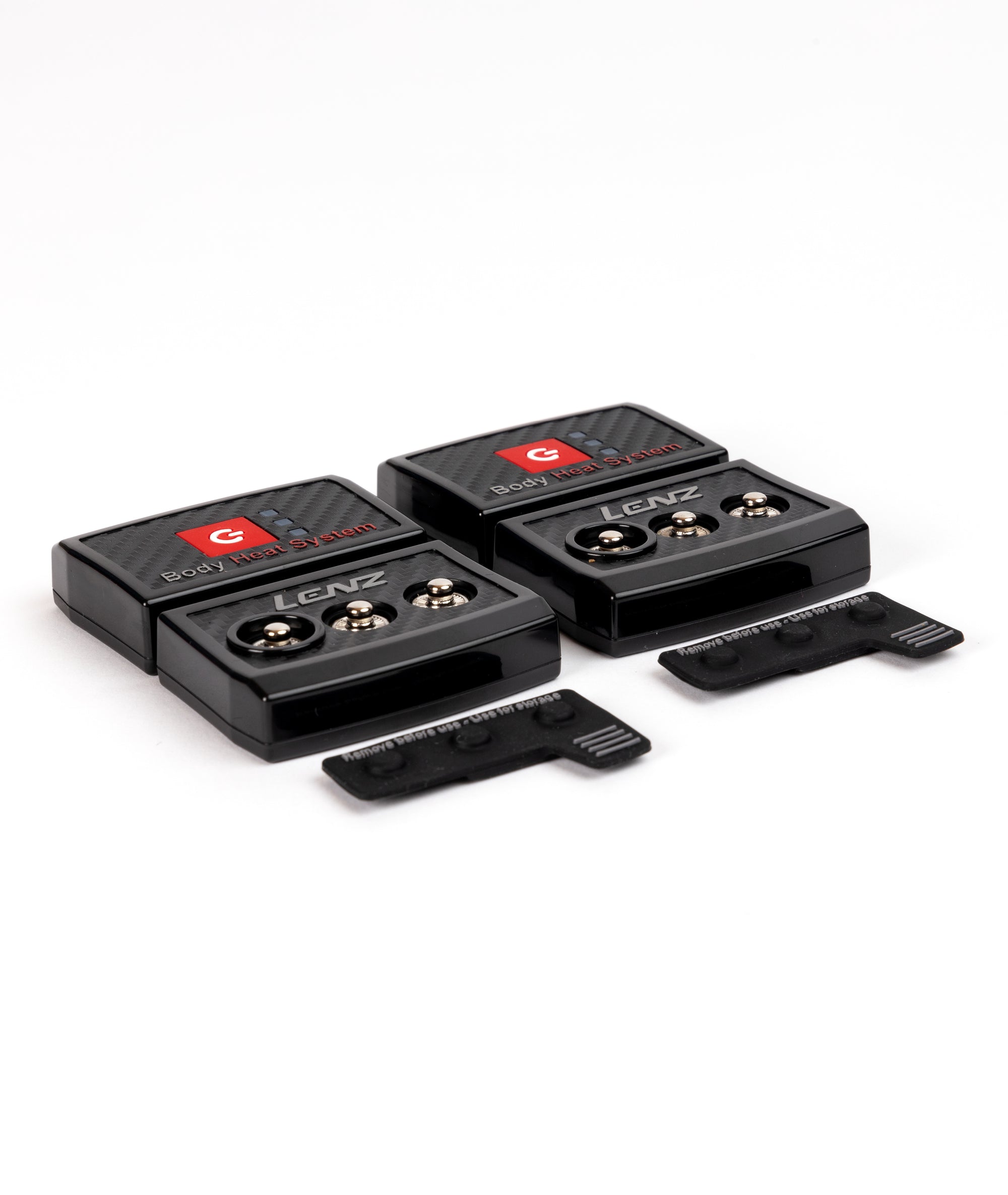 Lenz Body Heat Controller Zwei schwarze Lenz Body Heat System Controller mit zwei Abdeckungen auf weißem Grund.
