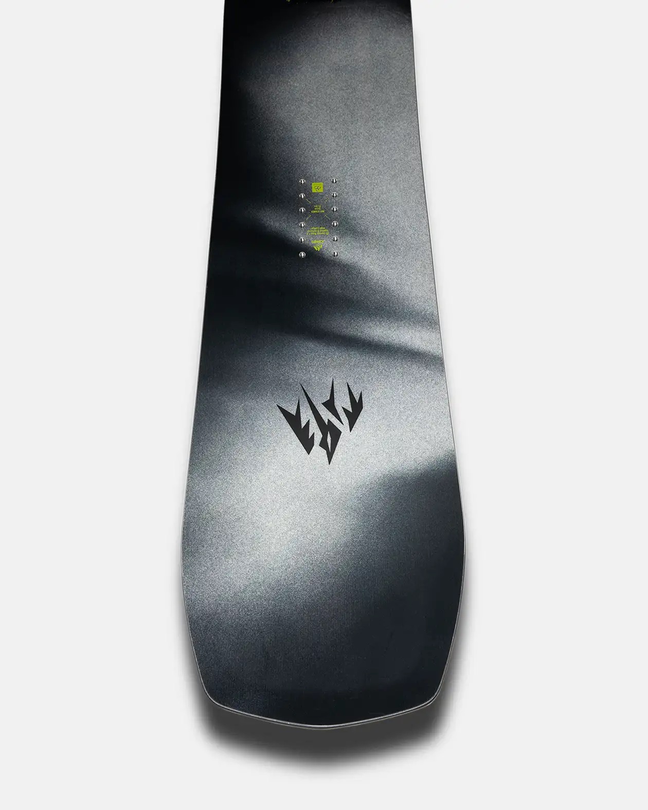 Ein Snowboard mit schwarzem Design und Logo. Das Brett hat Montagepunkte in der Mitte und einen Farbverlauf von hellgrau zu schwarz.