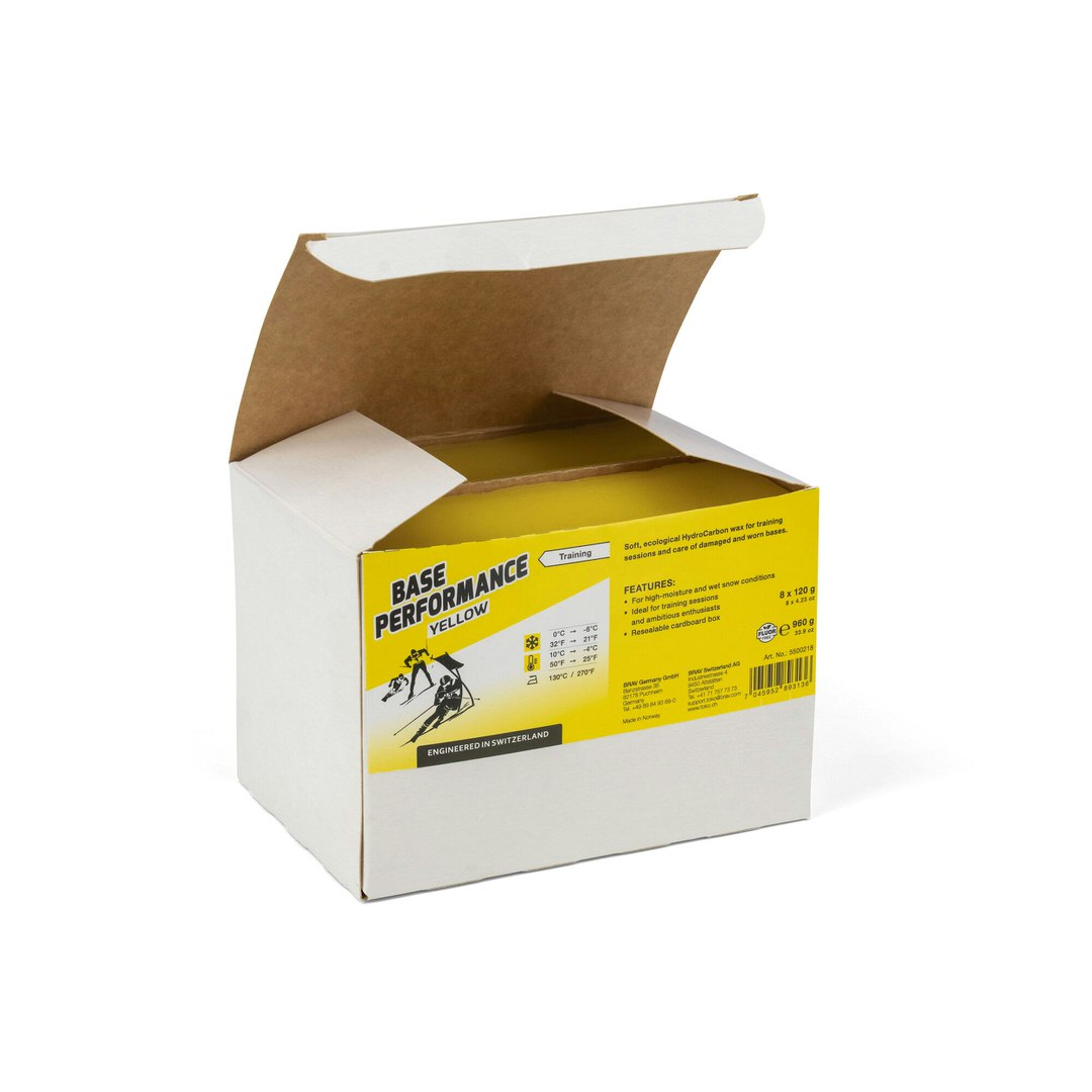Toko Base Performance Heisswachs Offene Verpackung Toko Base Performance Yellow Heisswachs mit gelbem Aufdruck und Skifahrer-Illustration.