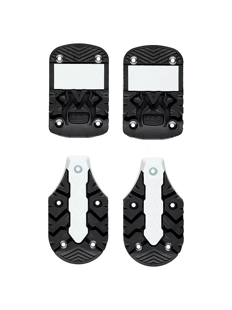 Shown are four black ski boot soles with white elements, arranged in pairs on a white background.