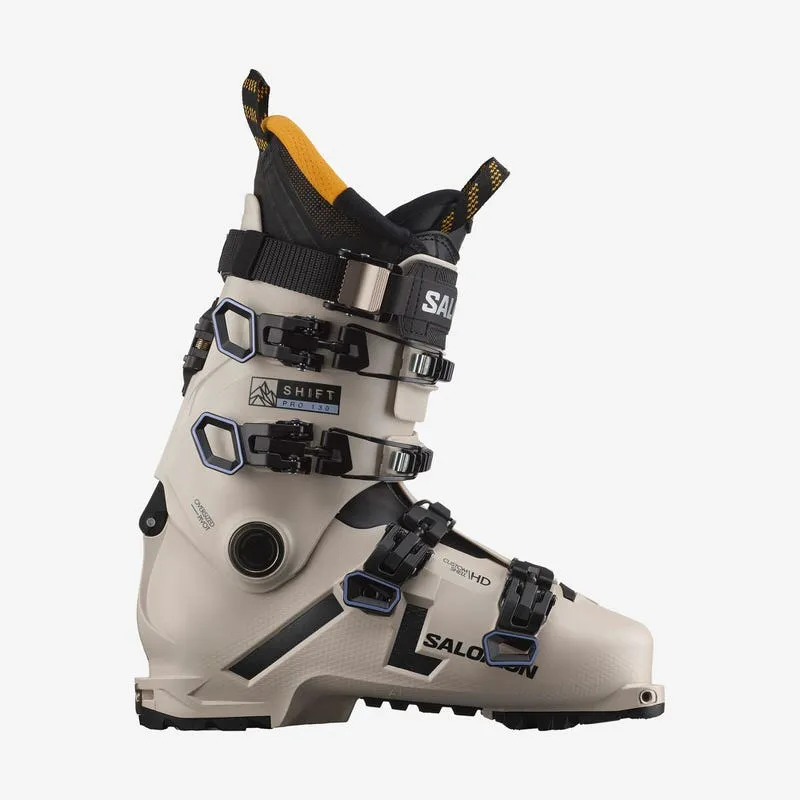 Beige Salomon Shift Pro 130 AT ski boot from the side, with black buckles and yellow liner.