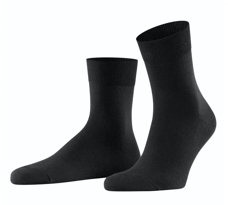 Two black men's socks, one upright, the other horizontal, both with ribbed cuffs.