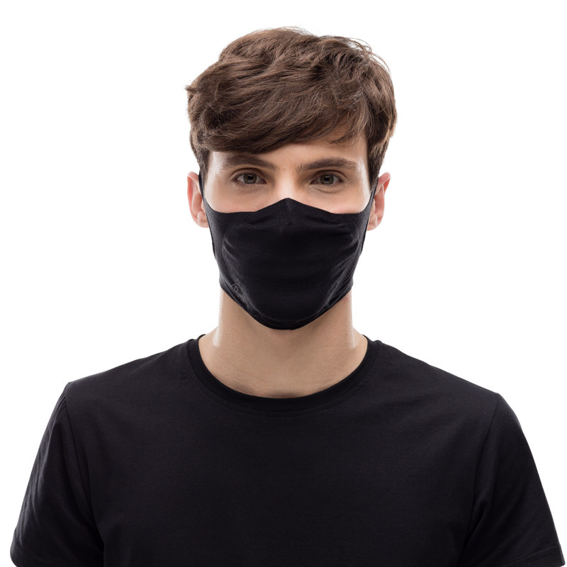 Eine Person trägt eine schwarze, wiederverwendbare Buff Filter Maske. Die Maske bedeckt Nase und Mund.