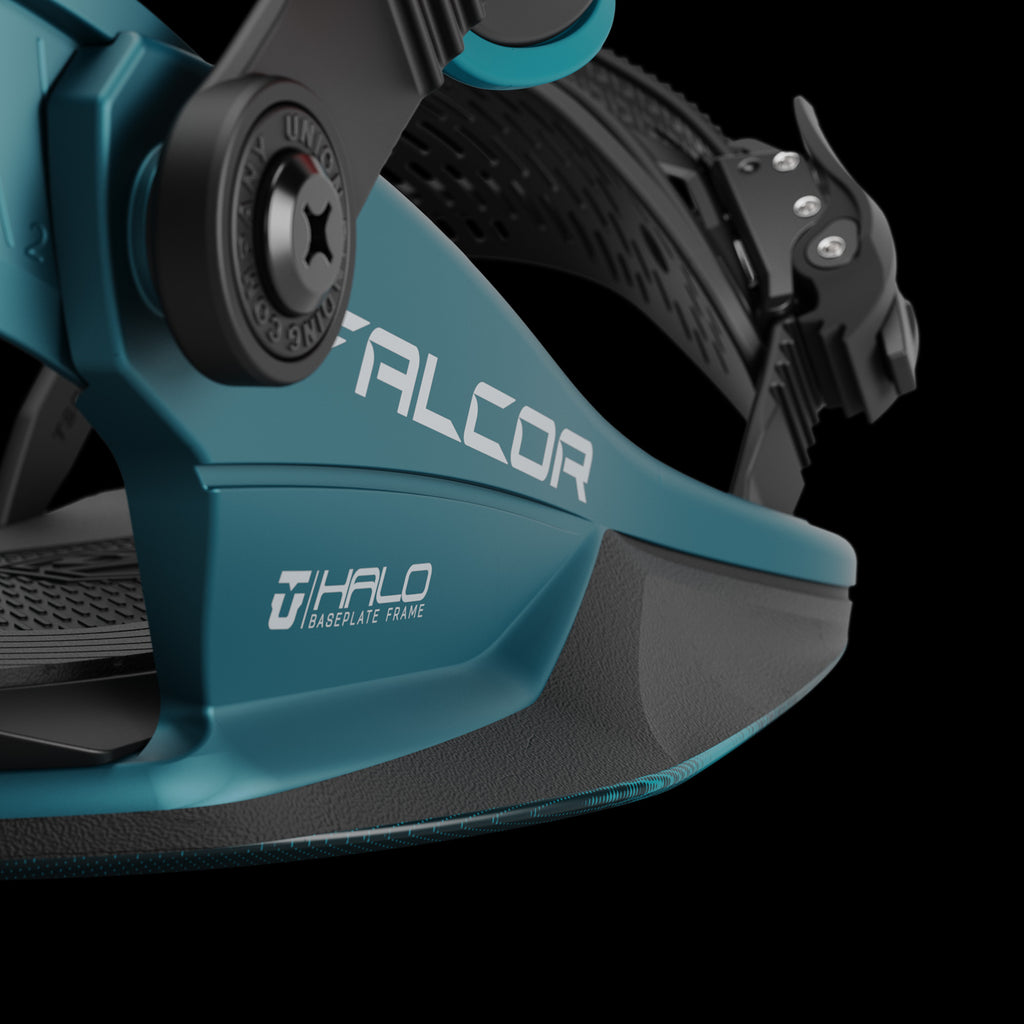 Close-up: Teal-colored Union Falcor snowboard binding with black highback and baseplate details.