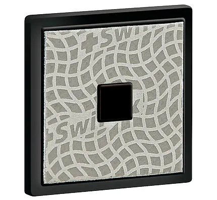 Square diamond file in black setting with pattern and dark button in the center.