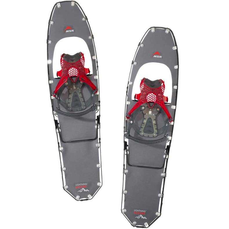 Graue MSR Schneeschuhe Zwei graue MSR Lightning Ascent Schneeschuhe mit roten Bindungen auf weißem Grund.