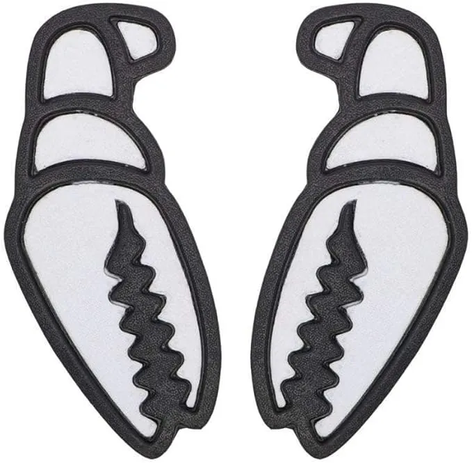 Two black snowboard stomp pads shaped like crab claws on a white background. Wide black frame with a white, jagged inner surface resembling crab teeth. Slightly textured surface for better grip. Set of 2 Mega Claw pads.