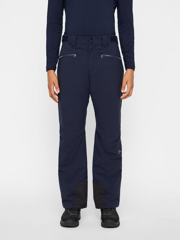 Marineblaue J.Lindeberg Truuli Skihose für Herren, frontal getragen, mit Reissverschlusstaschen und verstärktem Beinabschluss.