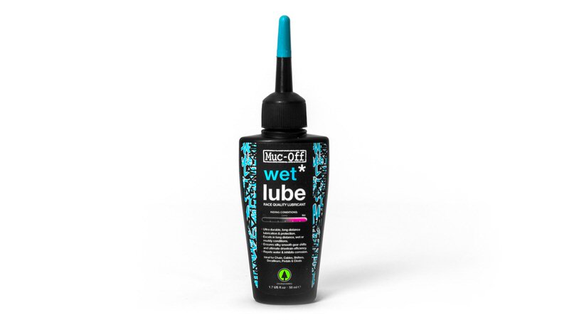 Schwarze Flasche Muc-Off Wet Lube mit blauem Applikator, Produkt für Fahrrad Kettenschmierung.