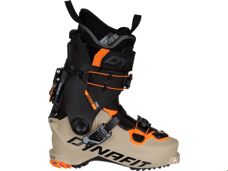 A Dynafit Radical Pro touring ski boot in khaki/orange, sideways. The boot has black elements and buckles. Visible Dynafit logo.
