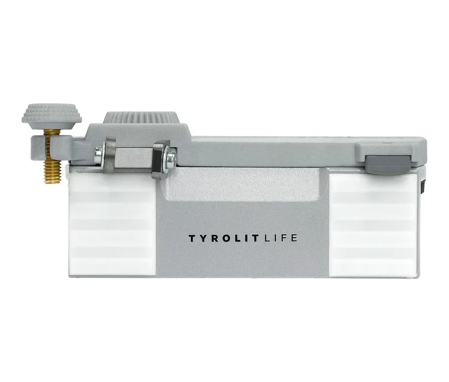 Utensile grigio Tyrolit Life con vite, dado e superficie illuminata, su sfondo bianco.