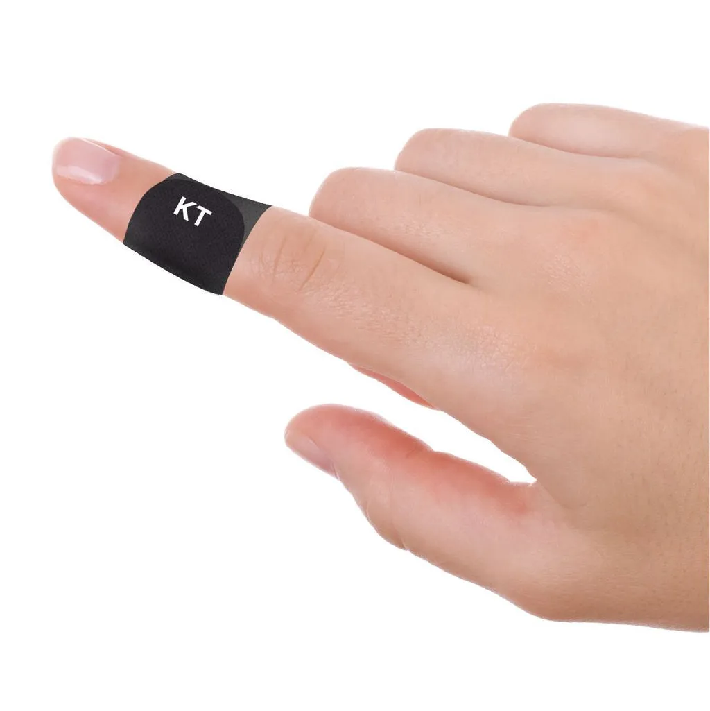 Hand with black blister plaster with white "KT" logo on the index finger.