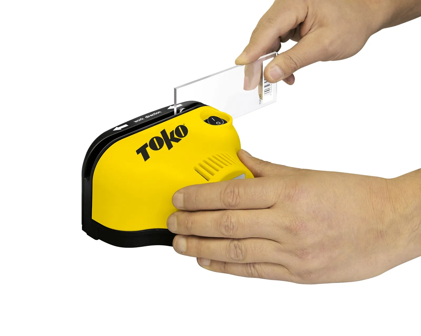 Yellow Toko device with hands inserting a transparent card. The device is labeled "work direction" with an arrow.