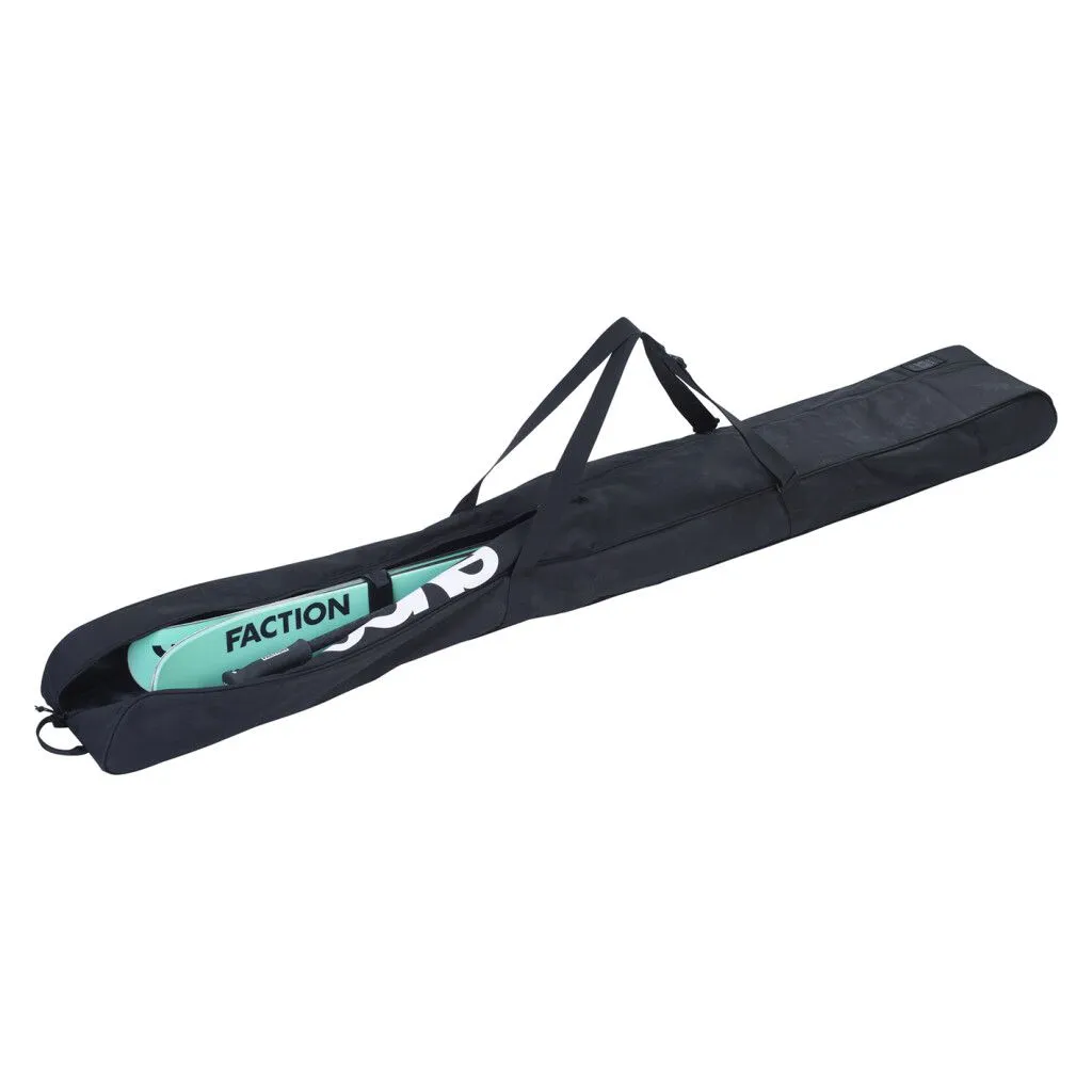 A long, black ski bag with skis partially sticking out. The lettering "Faction" is written on the skis.