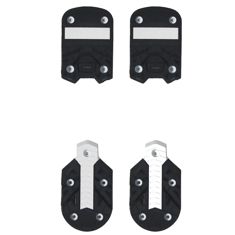 Four black ski touring binding plates with silver accents, two at the top and two at the bottom.