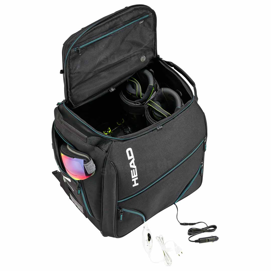 Geöffnete, schwarze Head Heatable Bootbag mit Skibrille und beheizbaren Skischuhen; Netzkabel sichtbar.