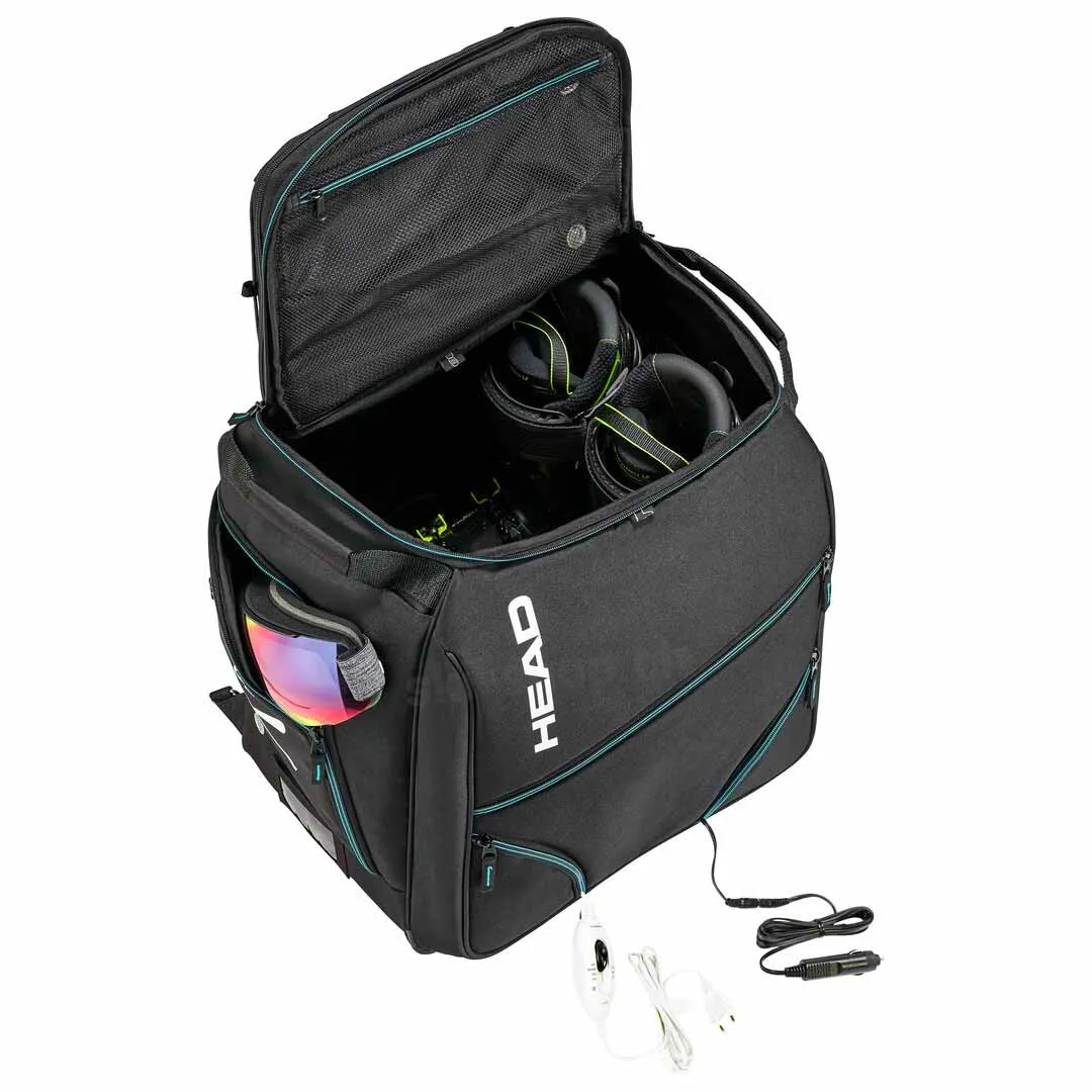 Bootbag Head Heatable noir ouvert avec lunettes de ski et chaussures de ski chauffantes ; cordon d'alimentation visible.