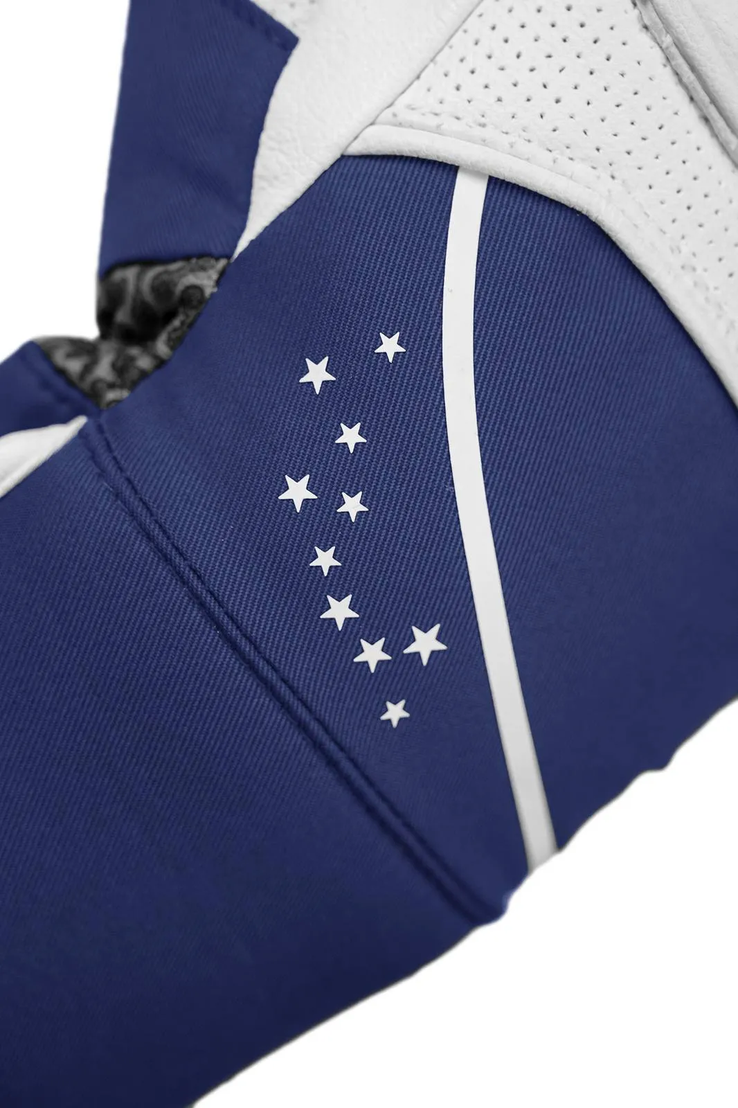 Close-up of a garment in blue with white stars and a stripe. The upper part is white and perforated.