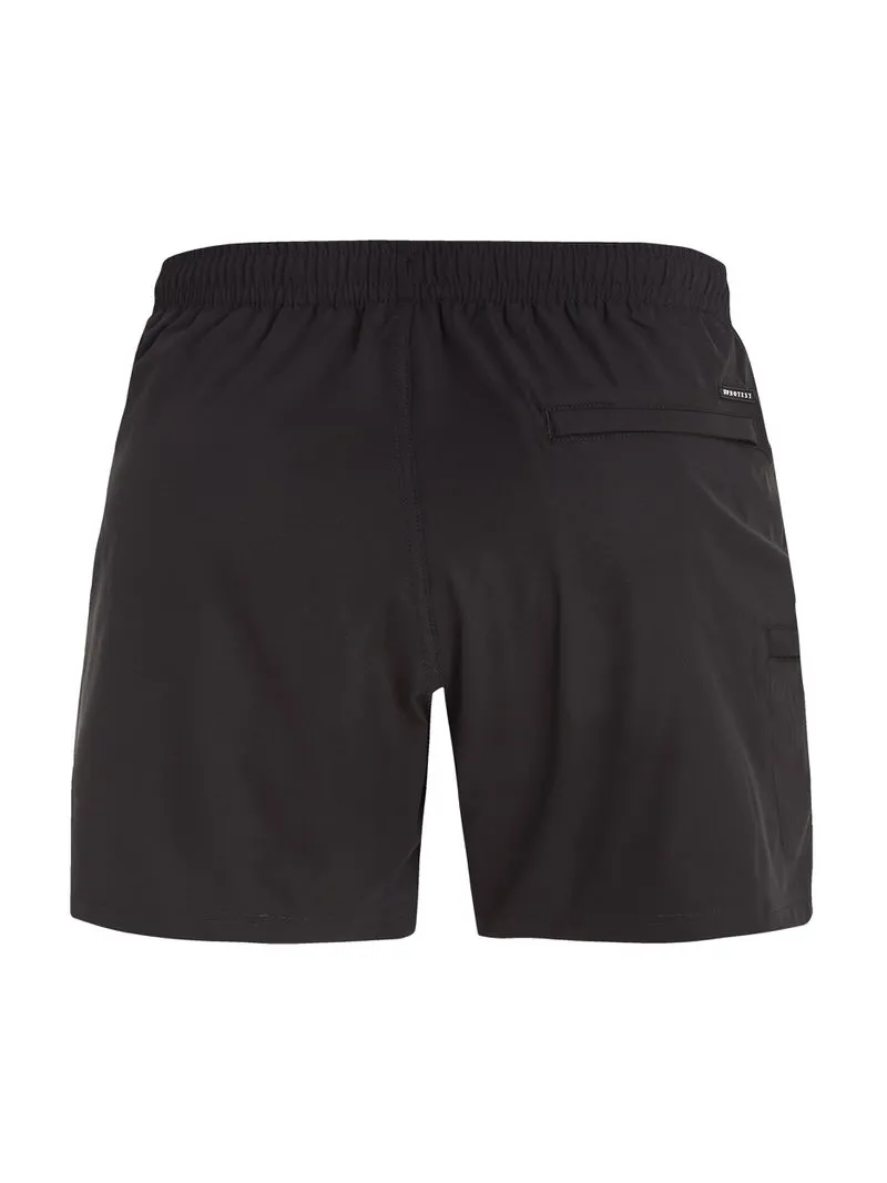 Schwarze PRTYESSINE Badeshorts von Protest, Rückansicht. Elastischer Bund, Gesäßtasche mit kleinem Logo.