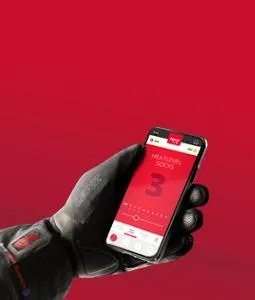 Hand with glove holds smartphone with red app to control the Lenz Heat Pant.