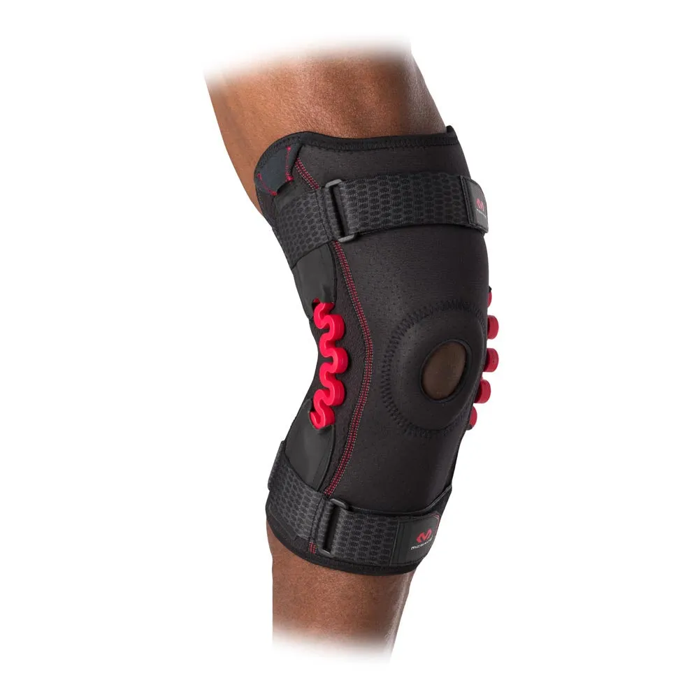 Close-up of a black MCDavid NRG knee support with red feathers on one leg.
