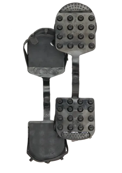 Black Cat Tracks ski boot soles with studs for better traction on ice, connected by a strap.