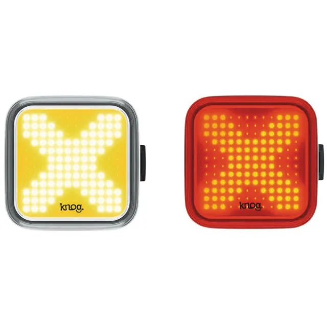 Gelbes und rotes Blinder X Fahrradlicht-Set mit X-förmigem Muster.