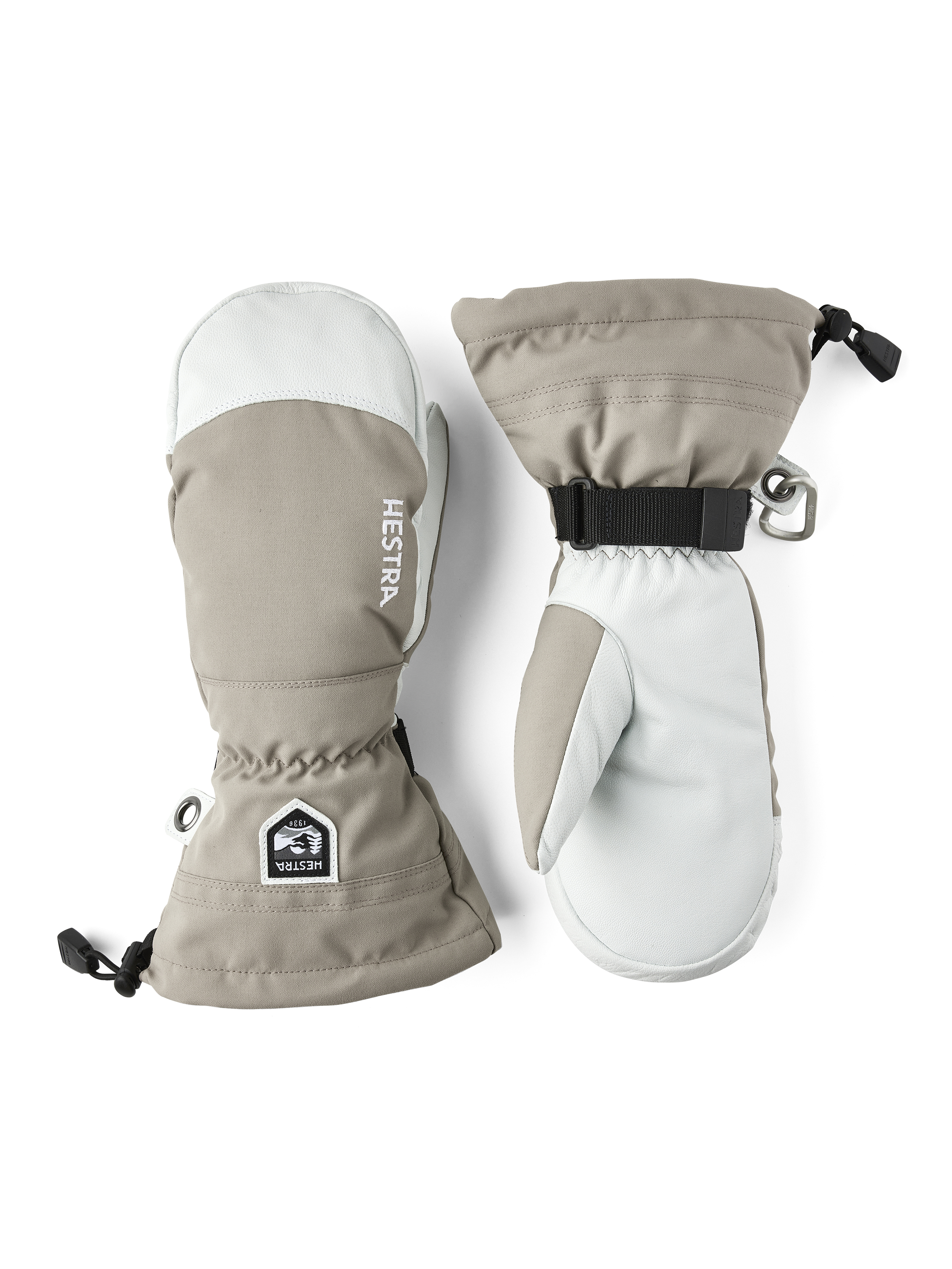 Hestra Moufles beige et blanc Deux Hestra Army Leather Heli Moufles de ski, beige et blanc, côte à côte sur fond blanc.