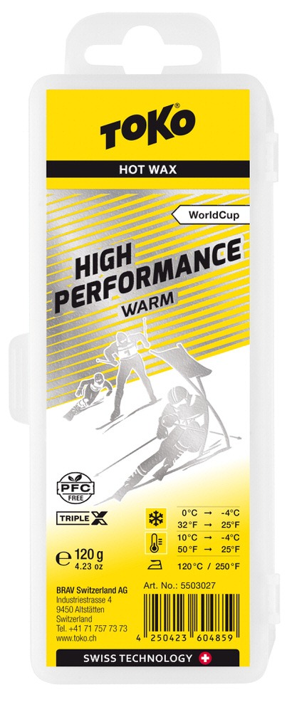 Verpackung Toko High Performance Triple X Warm Heißwachs, gelb-silber Design mit Skifahrer-Illustration und Temperaturhinweis.