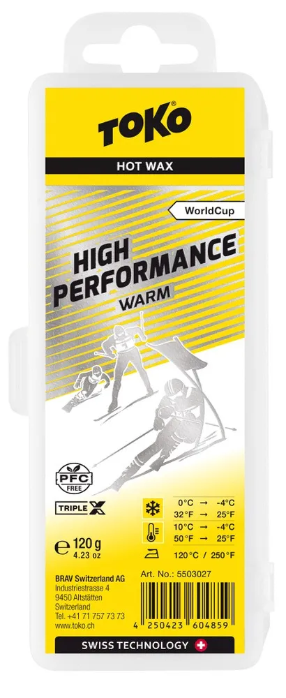 Verpackung Toko High Performance Triple X Warm Heißwachs, gelb-silber Design mit Skifahrer-Illustration und Temperaturhinweis.