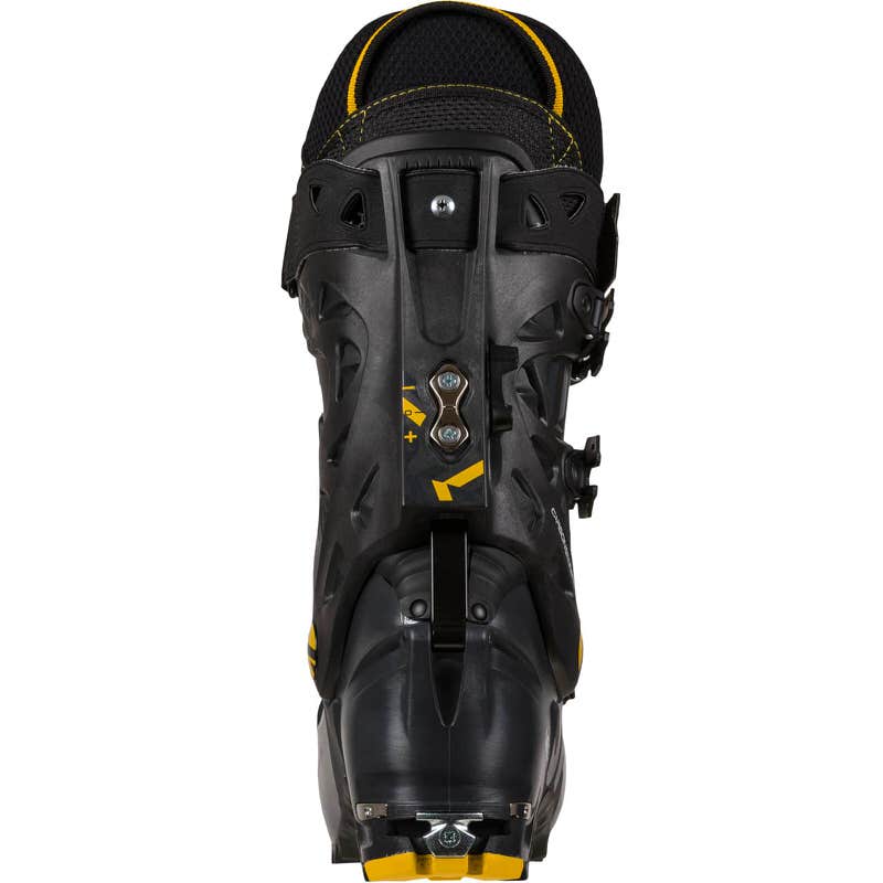 Schwarzer Skitourenschuh Vega Man von hinten, Details in Gelb. Das Verriegelungssystem Vertebra Technology ist sichtbar.