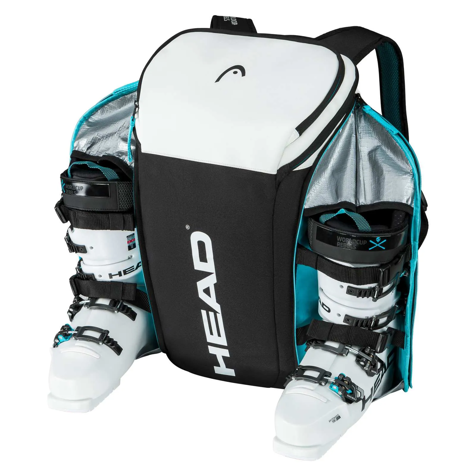 Sac à dos Head Rebels ouvert avec des chaussures de ski blanches dans des compartiments latéraux. Doublure argentée à l'intérieur, noire et blanche à l'extérieur.