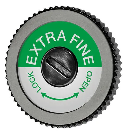 Mola rotonda grigia con etichetta verde e bianca "EXTRA FINE", vite al centro, senso di rotazione "LOCK" / "OPEN".