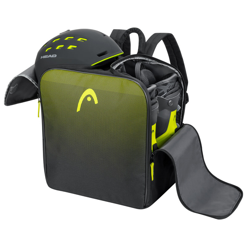 Offener, schwarzer Head Skischuh Rucksack mit Helm und Skischuhen. Gelbes Head Logo und Akzente.
